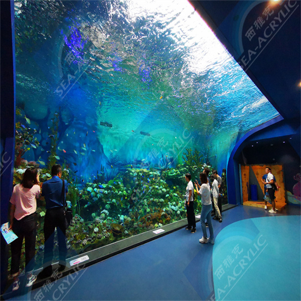 Create a tranquil atmosphere with a round acrylic fish tank in your space.