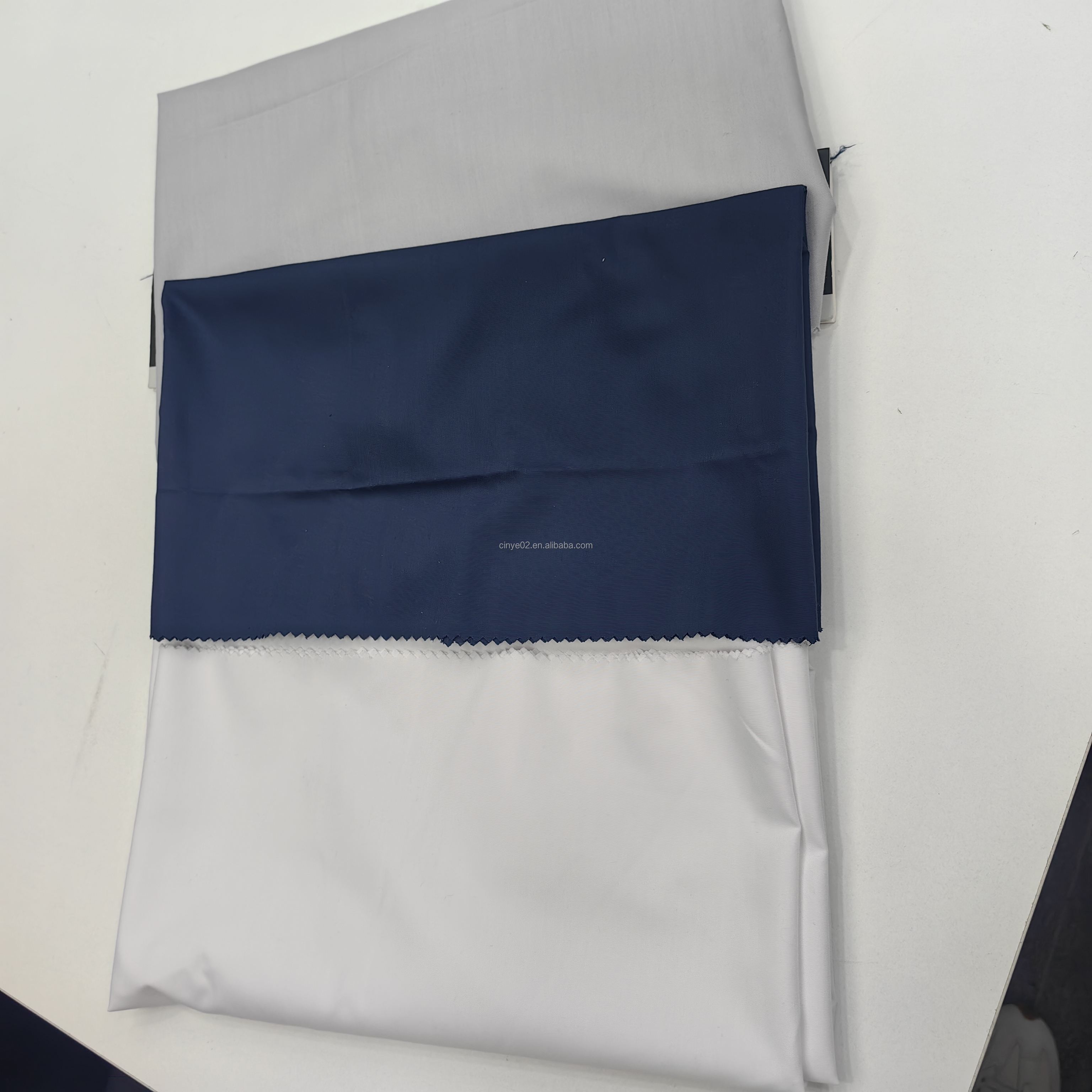 Wholesaler cheap micro fiber arabic thobe fabric for men spun polyester fabric toyobo fabric shirt arab thobe supplier