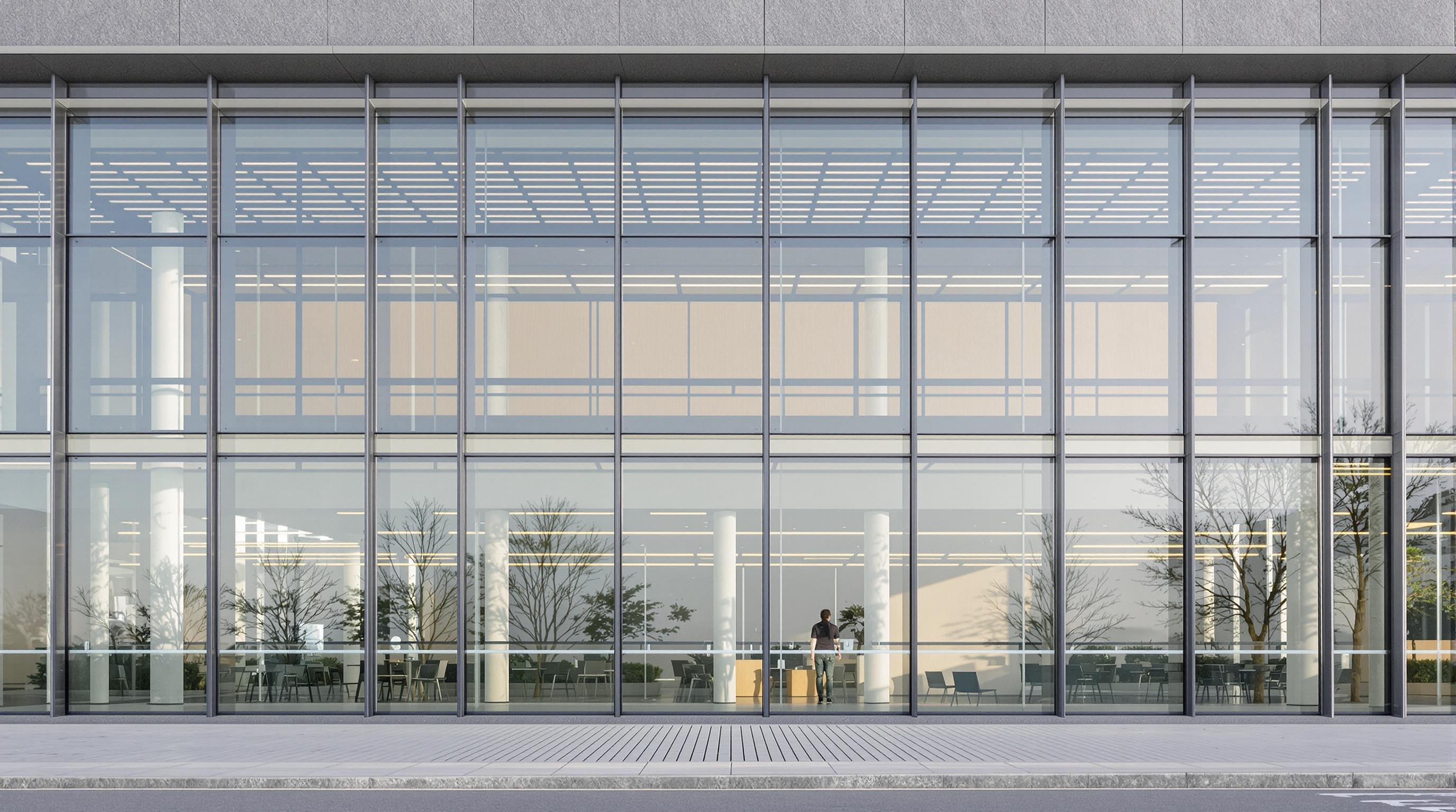 Office building exterior with double skin glass facade and photovoltaic panels, showing air gap and facade details