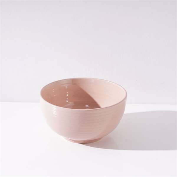 The vibrant pink hue of the ceramic bowl is sure to brighten up your kitchen.