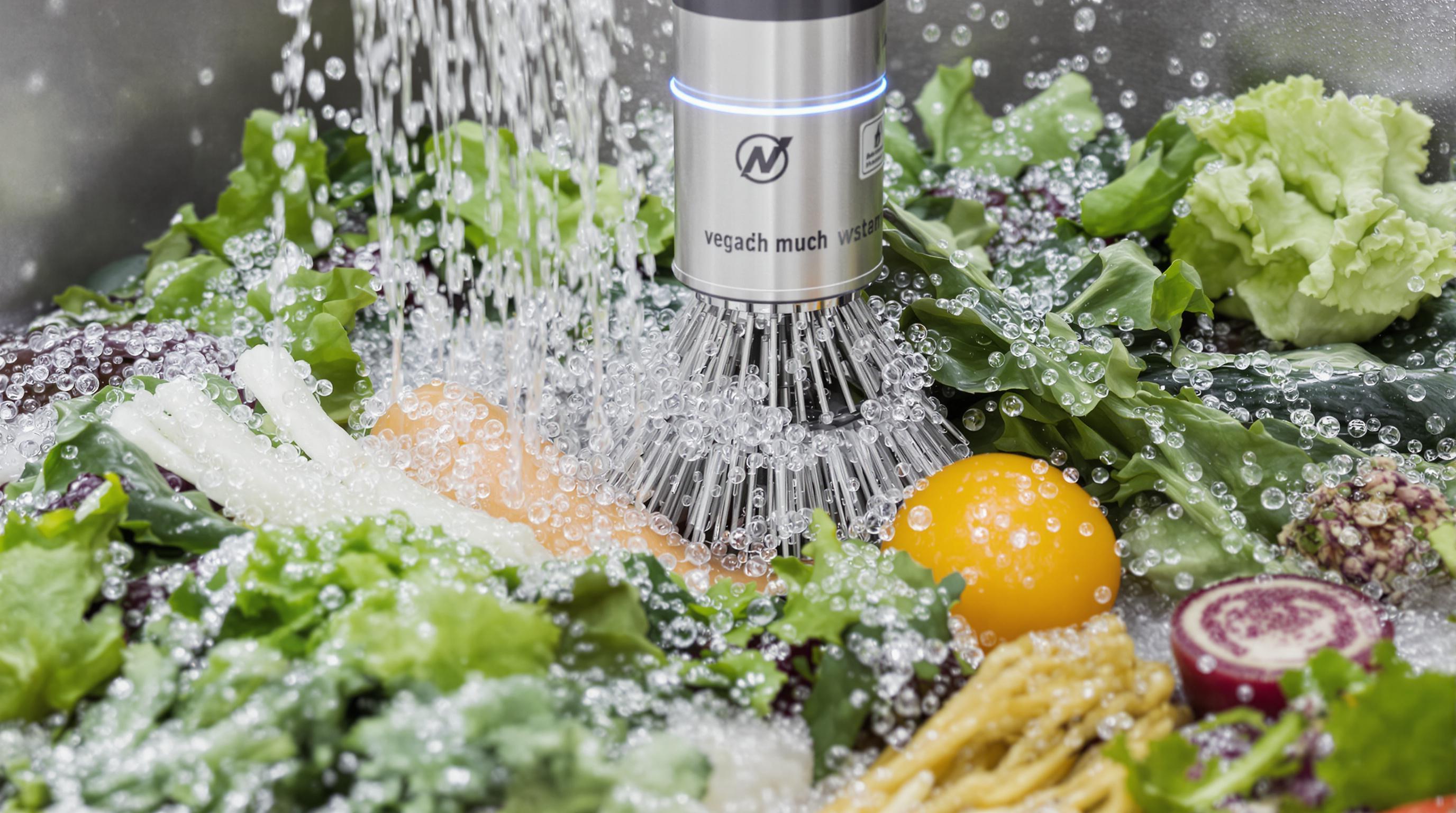 Close-up of modern vegetable washer using bubbles, brushes, and ultrasonic cleaning on vegetables
