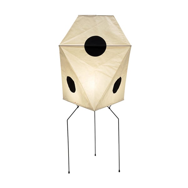Let the soft glow of a tall paper lamp illuminate your room