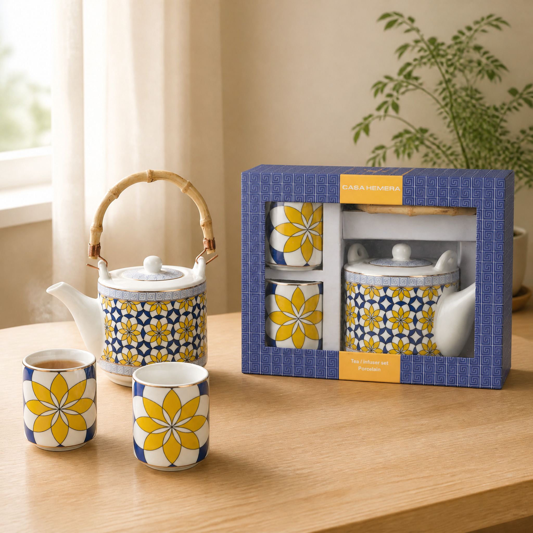 Juego de té de porcelana con borde dorado y motivos geométricos y florales, presentado en caja regalo