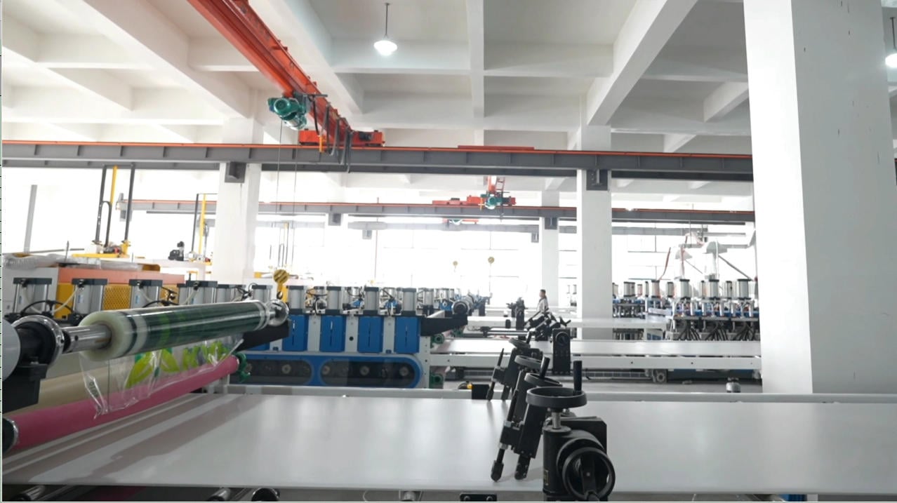 PVC foam board passing through an industrial calibration line.jpg