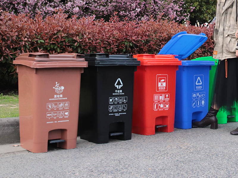 Outdoor plastic trash can fixed on a public walkway with UV-stabilised body.jpg
