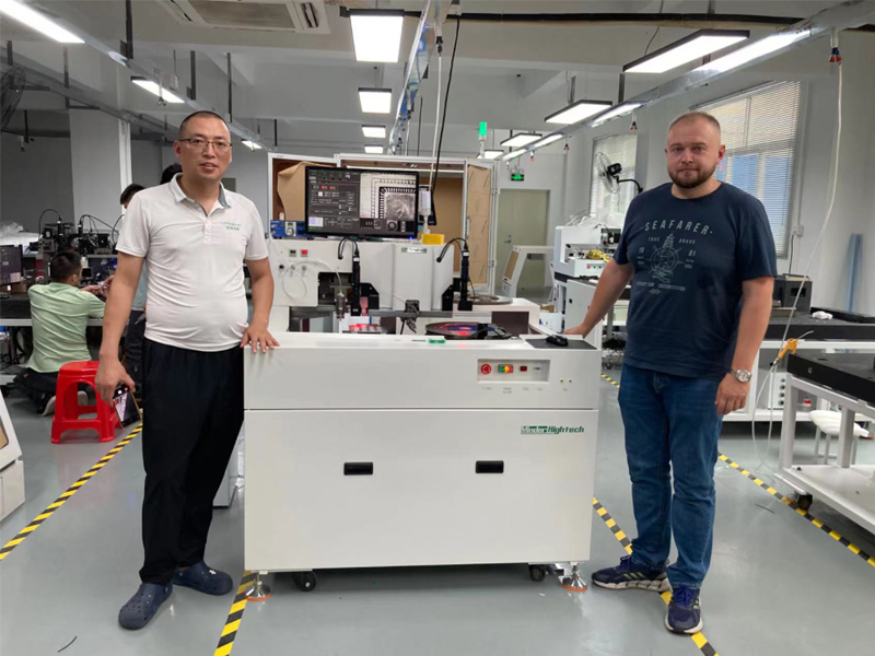 Minder Hu trains customer engineer on operation of Die bonder
