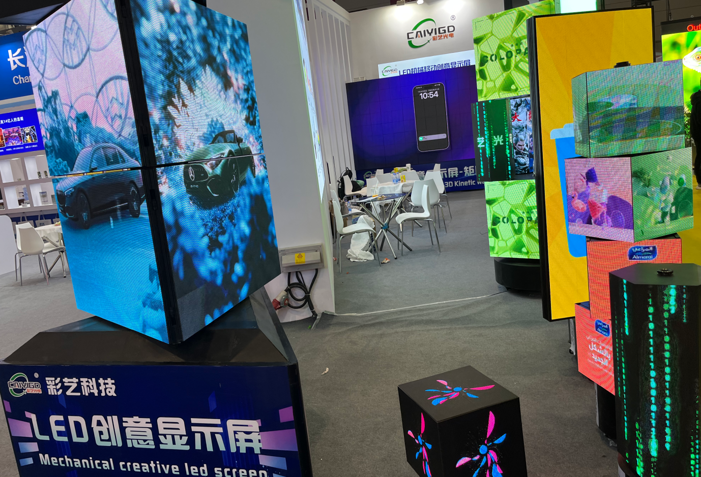 A diverse range of custom creative LED displays, including stacked LED cubes and mechanical screens, breaking traditional boundaries at a trade show booth