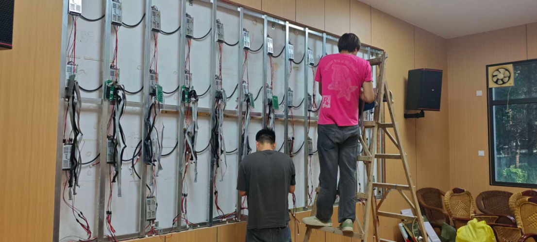 Technicians installing power supplies and receiving cards for premium P1.53 LED display