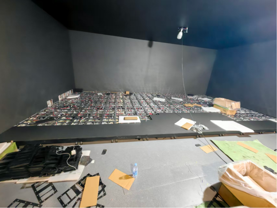 Technicians installing P1.86 ultra-high-definition LED modules for a museum's immersive floor display