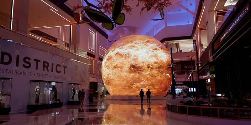 Innovative giant outdoor spherical LED video wall displaying vibrant 3D globe content as a city landmark