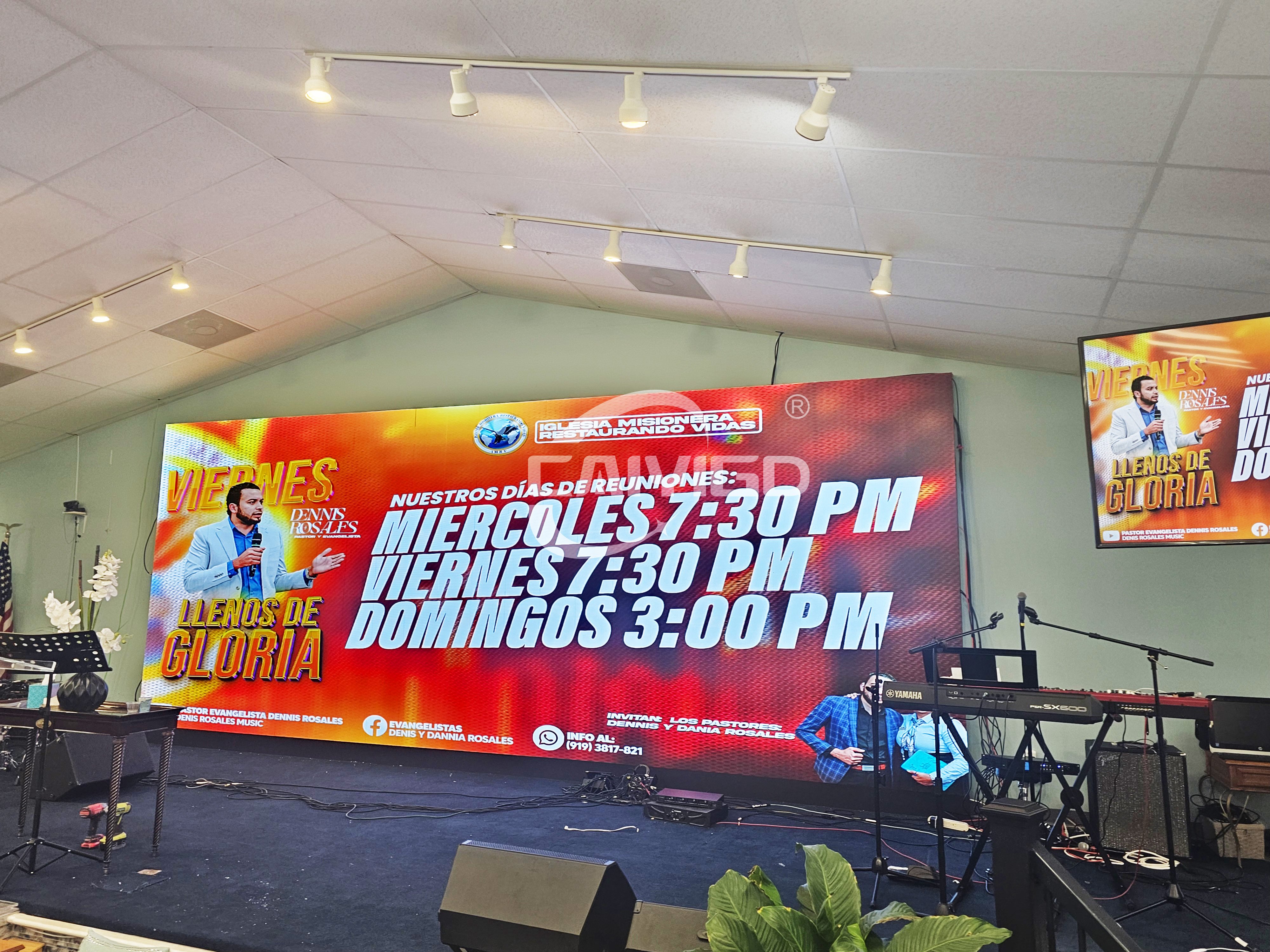 Wide view of a fully installed P2.5 indoor church LED screen displaying vibrant event schedules on the main stage.jpg