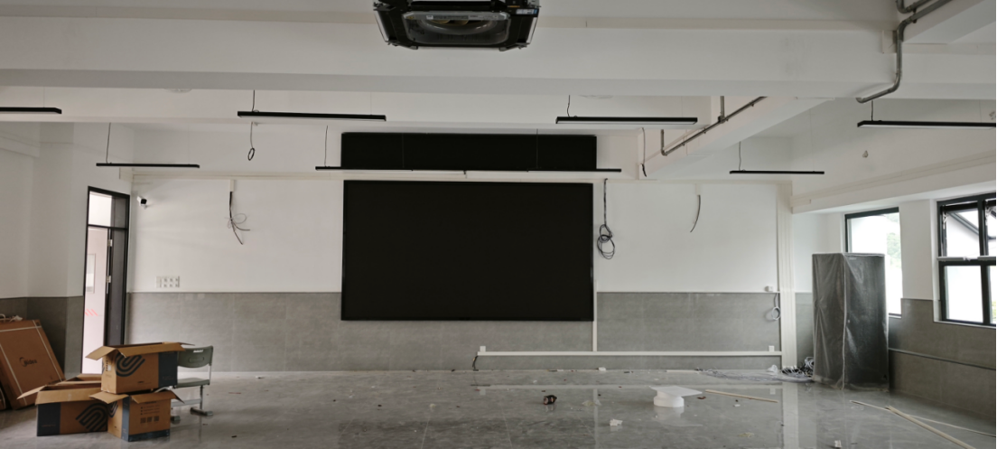 The fully assembled P1.53 narrow pixel pitch LED video wall, seamlessly flush-mounted in a modern corporate showroom before powering on.