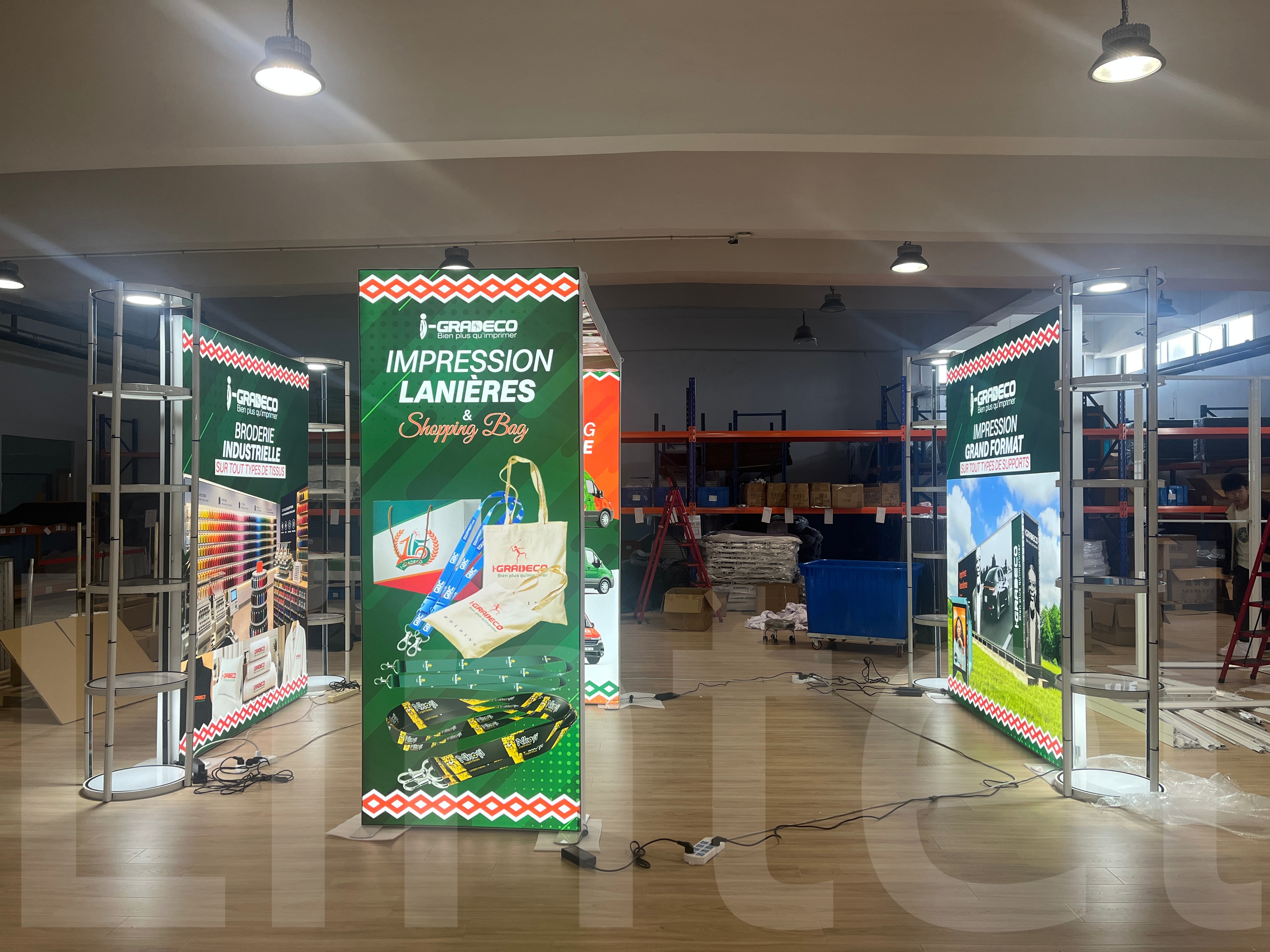 Two 2m x 2.5m lightbox backdrops paired with Twist Tower displays, featuring a lightbox archway placed in the center. (2).jpg