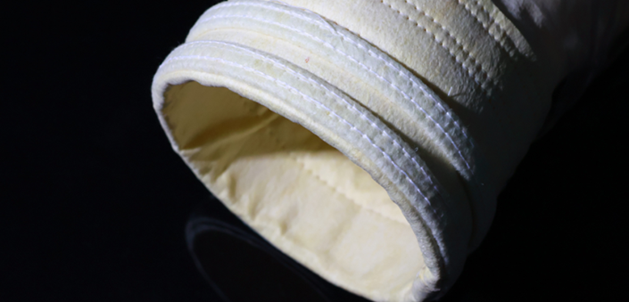 Customized head treatment for dust collection filter bags.