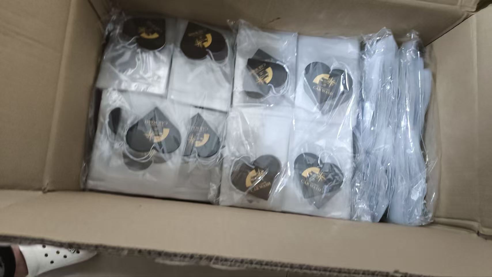 Bulk order of round custom printed car air fresheners, neatly packed into export cartons with individual transparent sealing bags..jpg