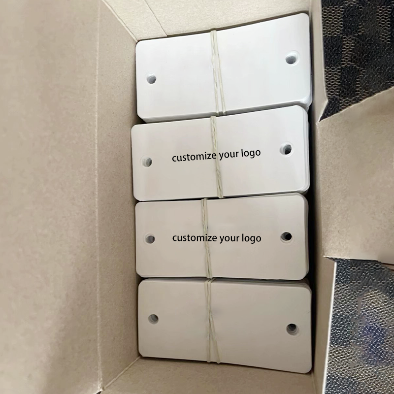 Bulk blank custom PVC hang tags bundled and packed inside export carton ready for shipment.png