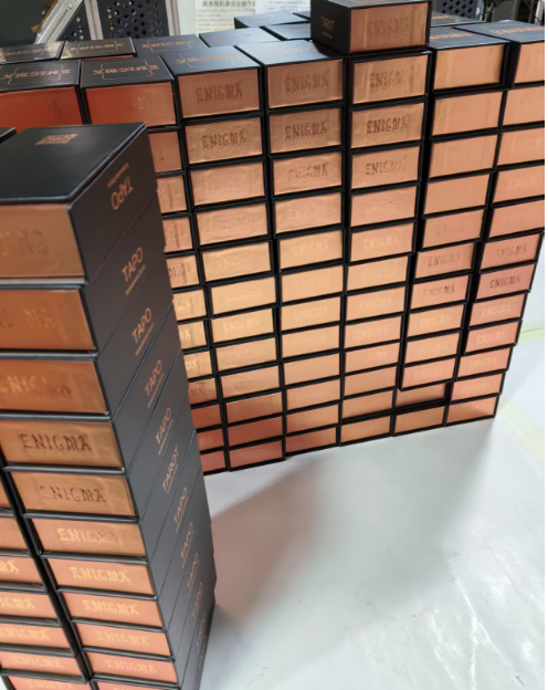 Mass stock custom black copper interior rigid flip tarot boxes stacked in factory warehouse, wholesale oracle card gift packaging.png