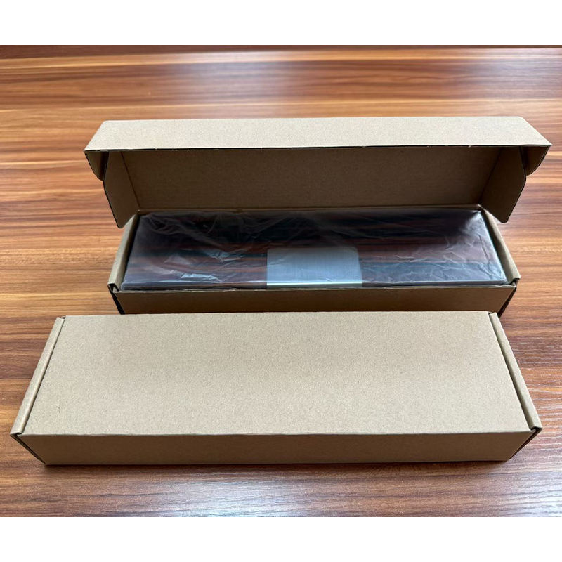 Two kraft mailer cartons, one open to show the wooden box wrapped in clear protective film inside.jpg