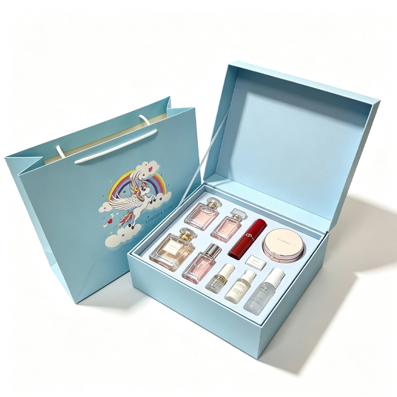 Open gift box with a compartment inner tray holding perfume bottles and a lipstick as display props.jpg