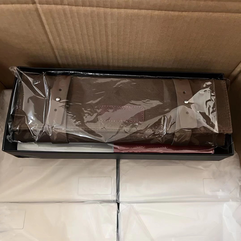 Canvas watch roll wrapped in clear plastic inside black gift box in warehouse export carton.jpg