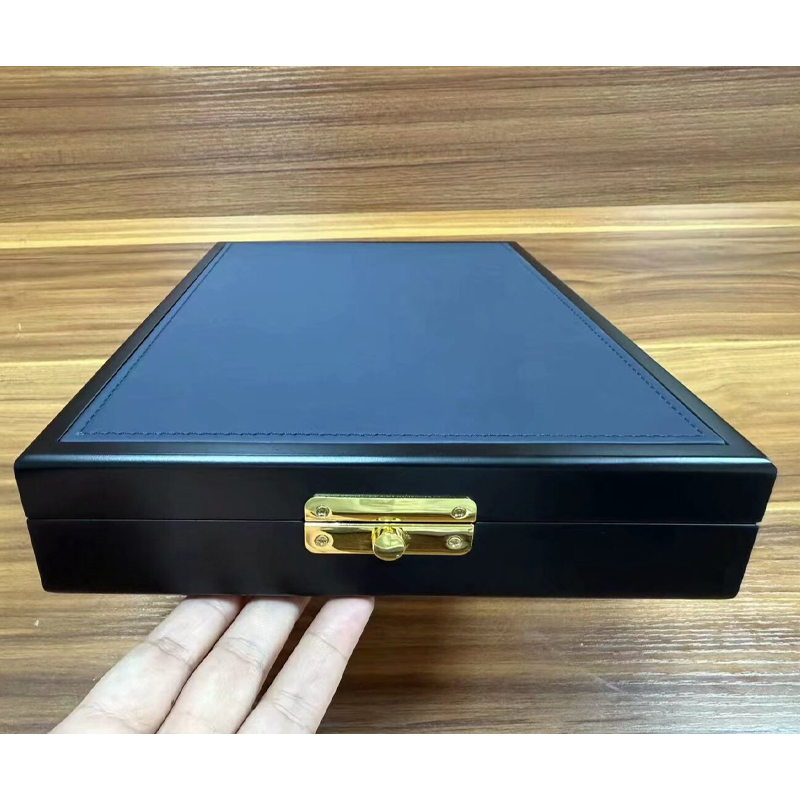 Front view of the wooden jewelry box showing the stitched navy lid panel and the gold-tone latch.jpg