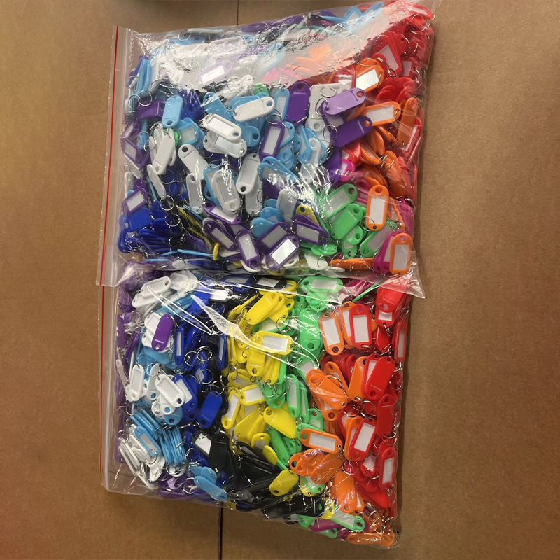 Large quantity mixed-color plastic key tags packed in transparent zip bags, bulk shipment for wholesale.png