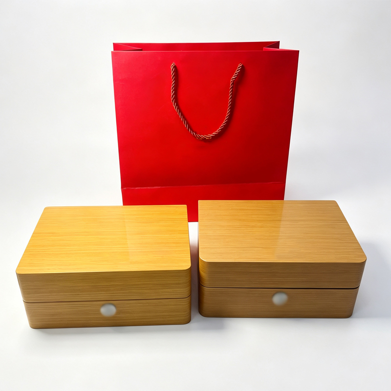 Closed wood watch boxes with red gift bag in the backgroun(4b844ff3e9).jpg