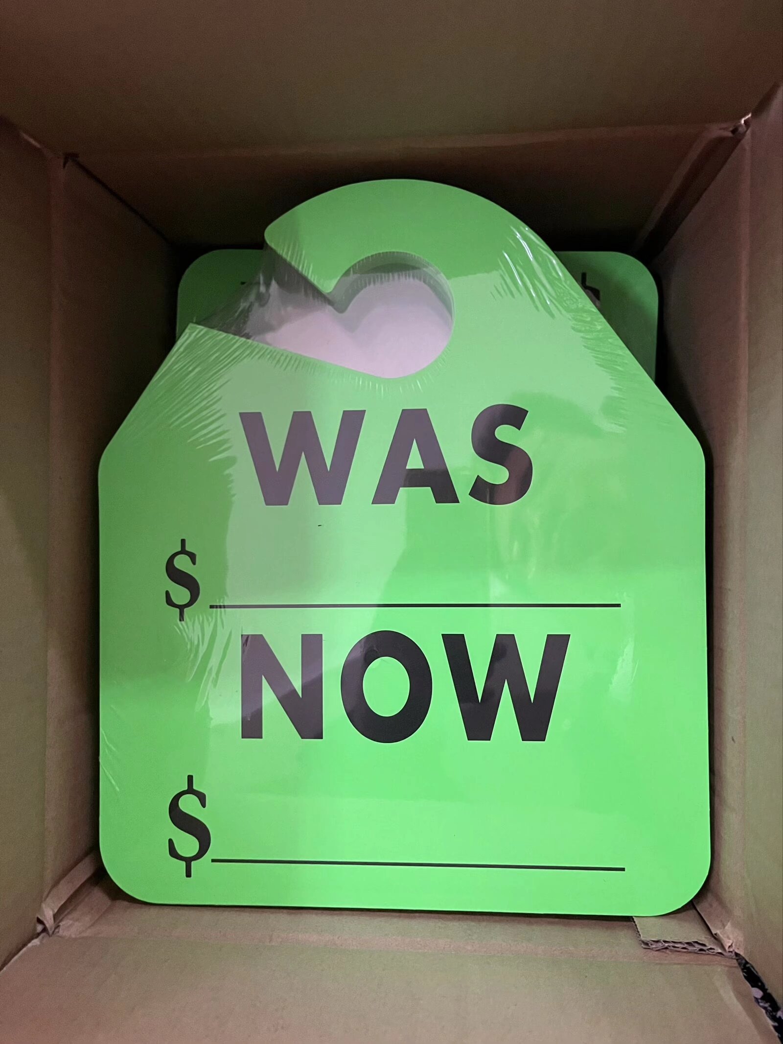 Bulk green fluorescent WAS NOW sale hang tags wrapped in shrink film inside export carton.jpeg