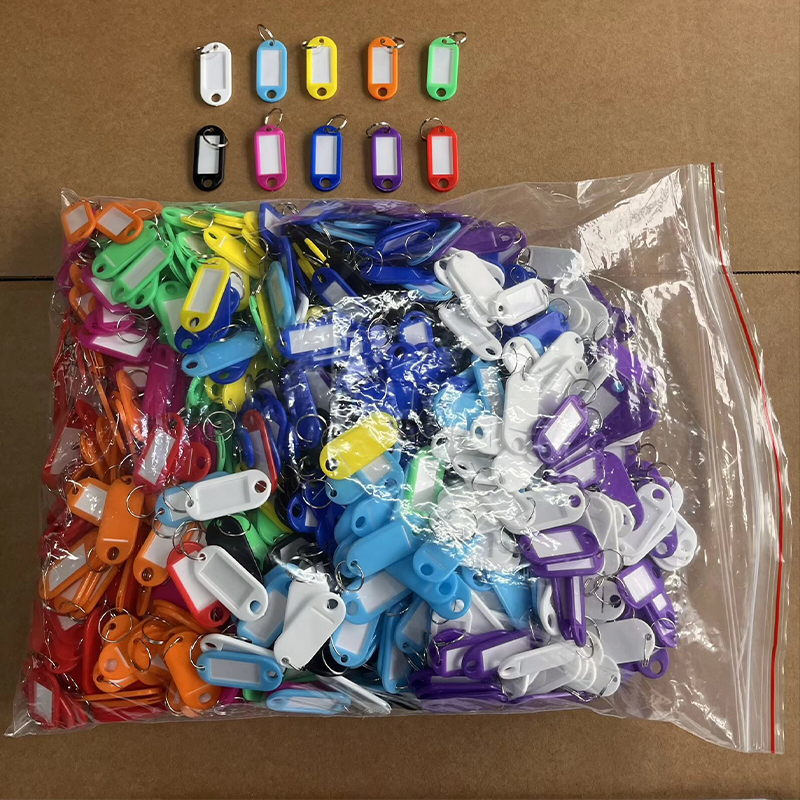 Bulk packaged mixed color plastic key tags with split rings, ziplock bag wholesale stock photo.png