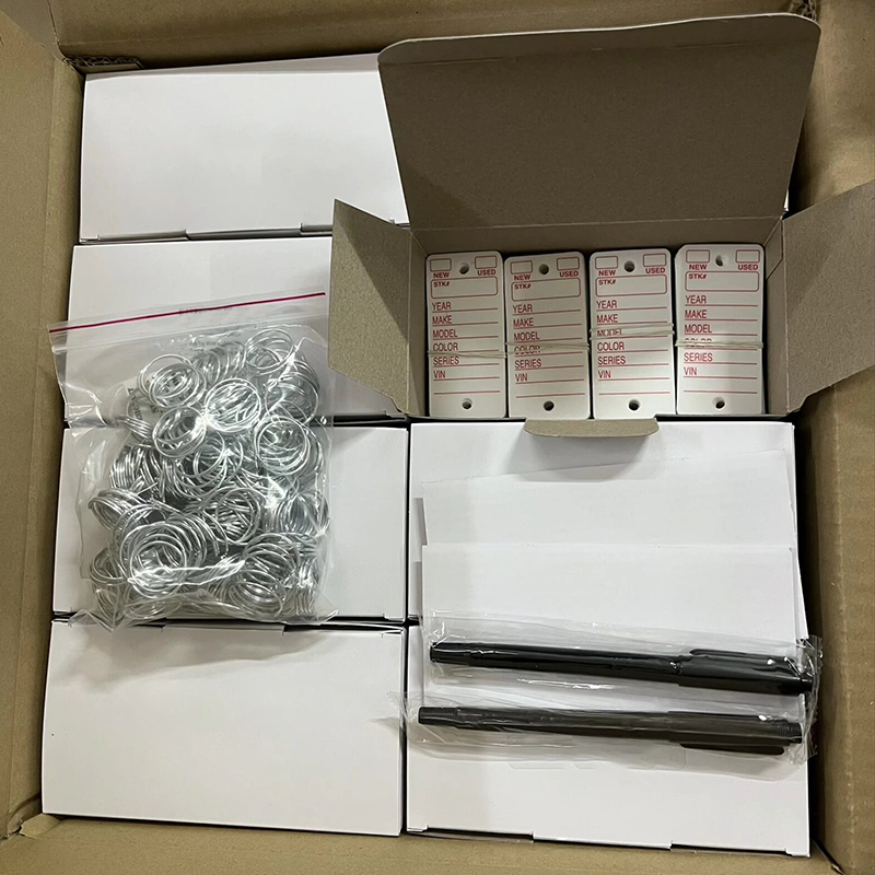 Bulk packing of auto dealer printed key tags, including tags, split rings and marker pens inside carton.png