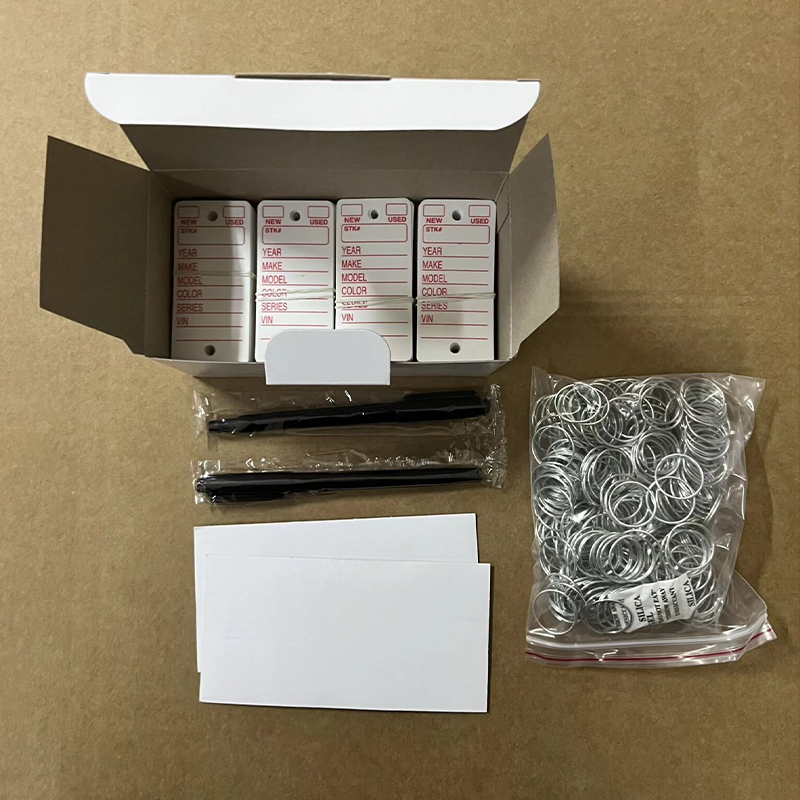 Open box kit of printed car dealer key tags with accessories, wholesale package display.png