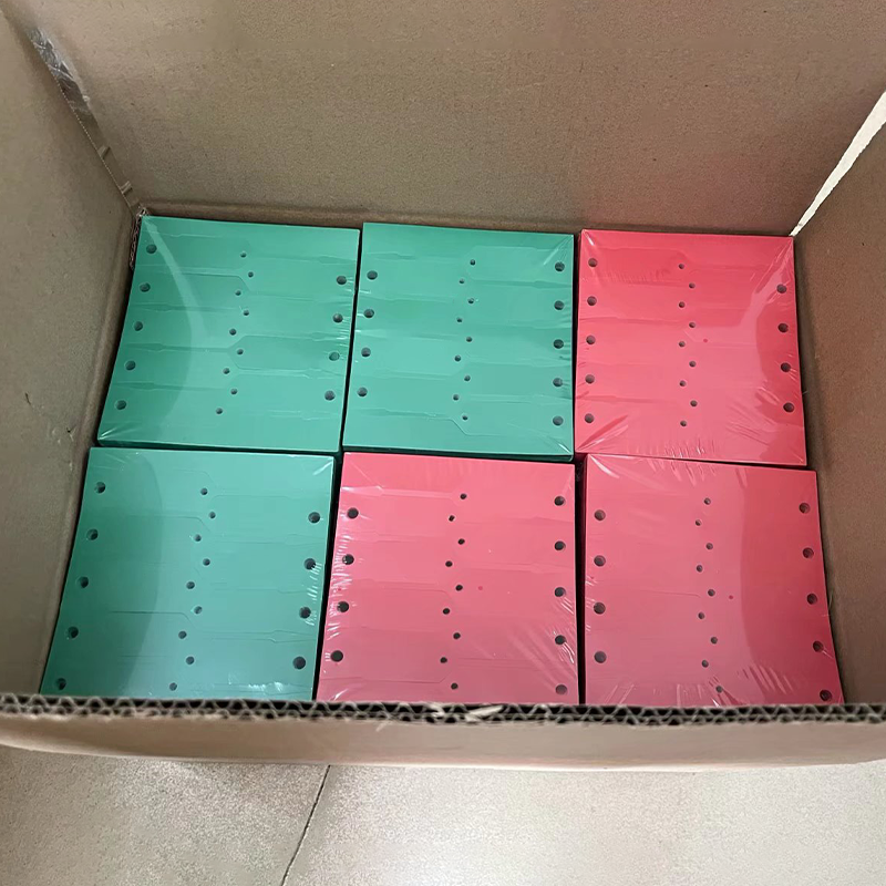 Bulk finished yellow disposable arrow plastic hang tags stacked inside export carton ready for shipment.png