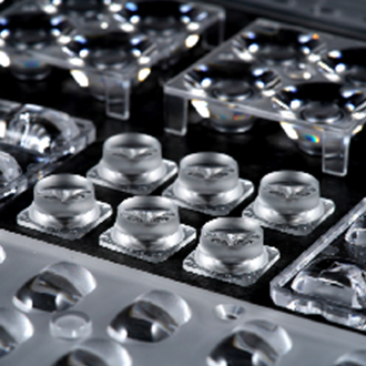 How does plastic moulding reduce material waste in mass production?