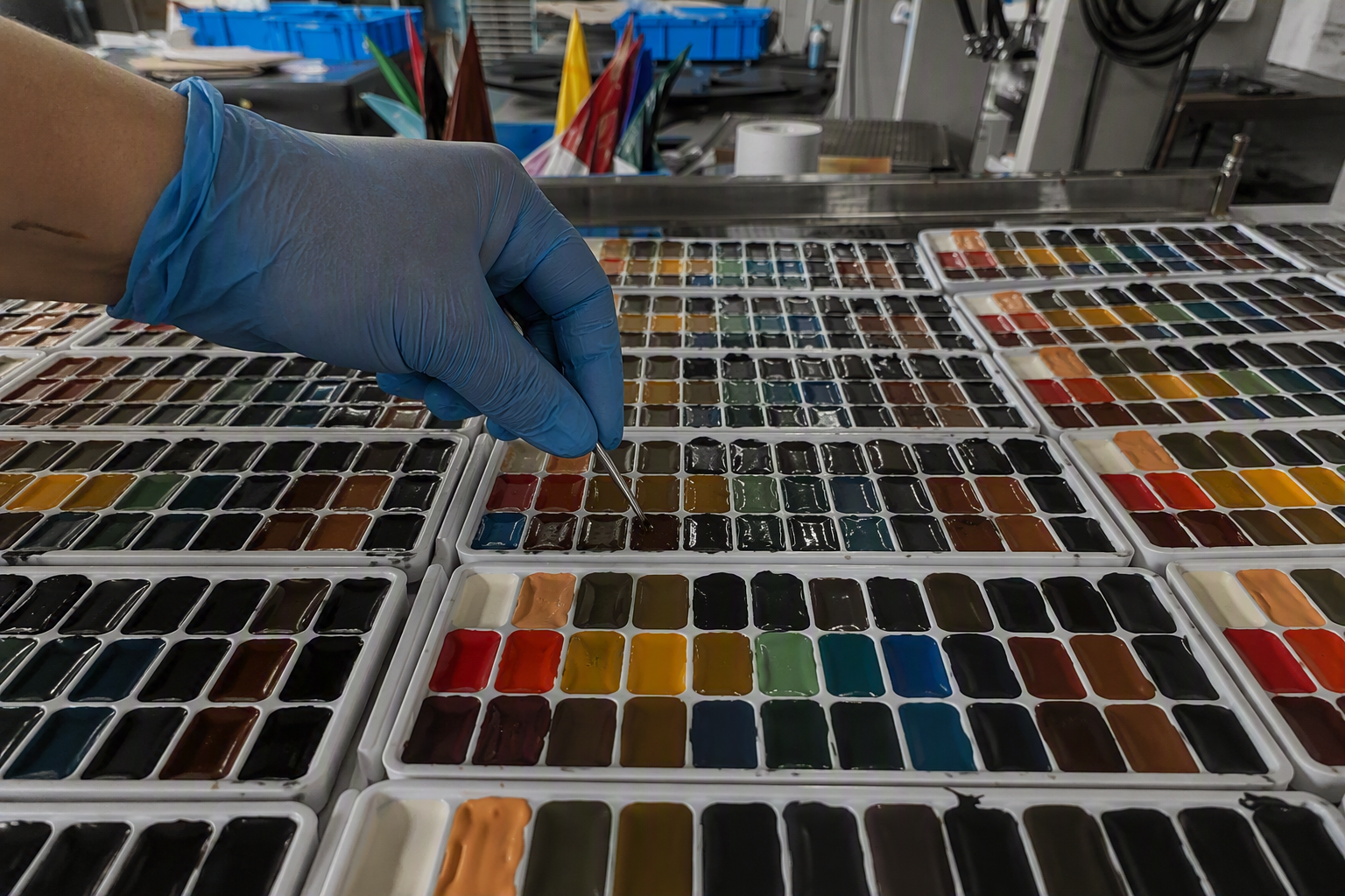 Quality control inspector testing watercolor toxicity and color fastness in laboratory