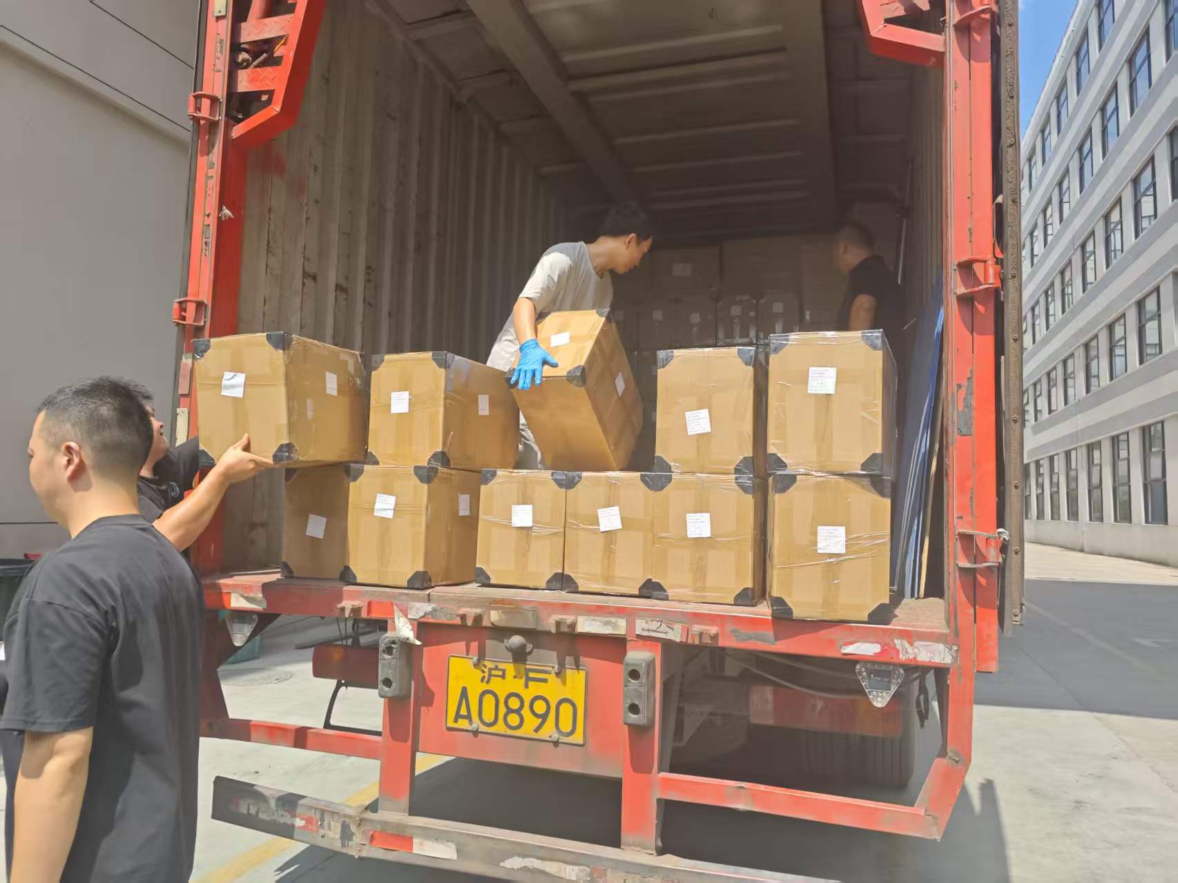 Palletized watercolor paint boxes loaded into shipping container in logistics warehouse