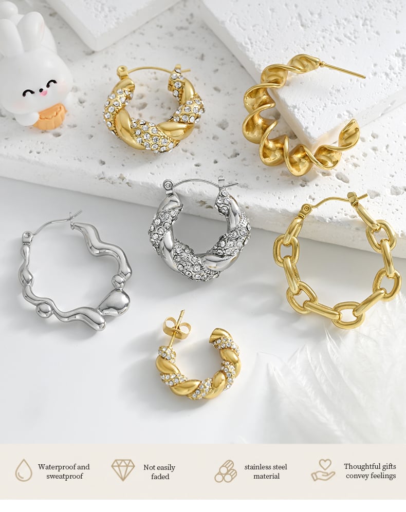 Gold tone twisted hoop earring with spiral design on transparent background.jpg