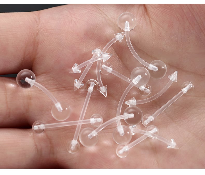 Hand holding clear acrylic piercing retainers collection.jpg
