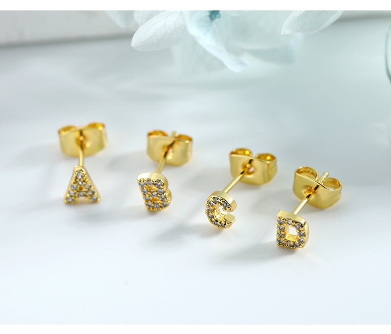 Letter stud earrings showcase with gold tone finish.jpg
