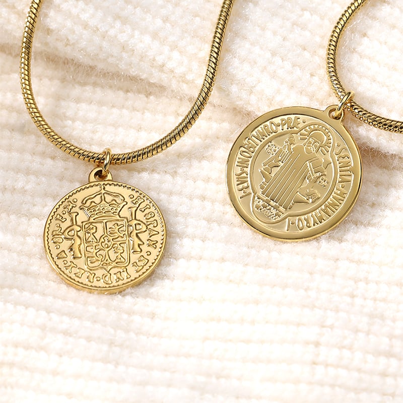 Hand holding gold and steel coin pendant necklaces, product detail.jpg