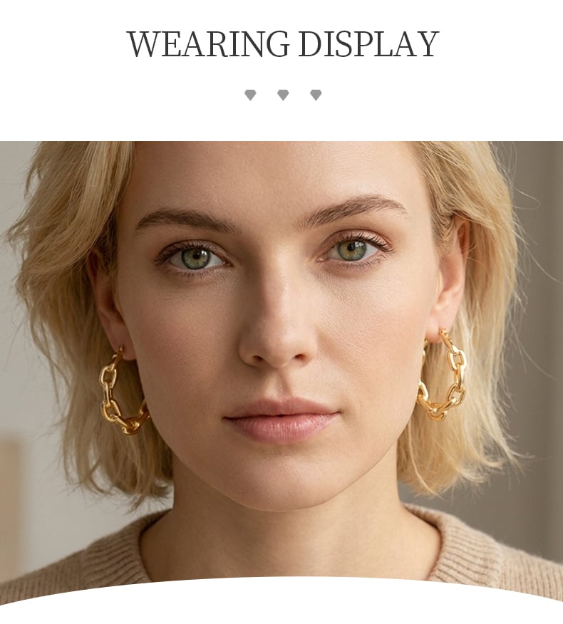 Close view of gold tone twisted hoop earrings with polished surface.jpg