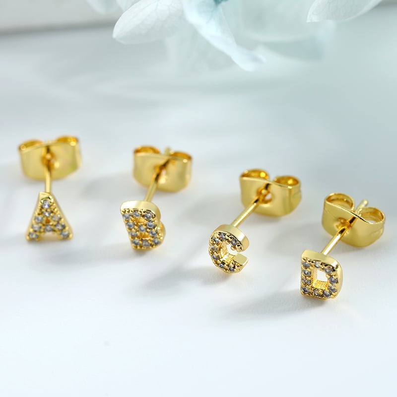 Letter stud earrings worn in daily styling.JPG