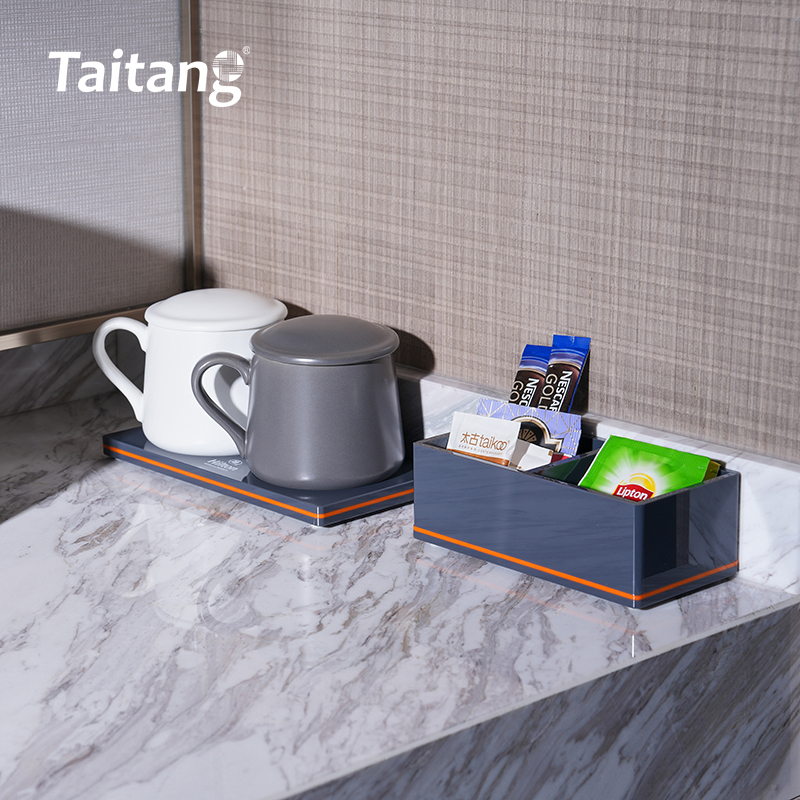 Close-up of a Taitang in-room guest amenity station set with a mug and a well-stocked tea sachet organizer box on a marble surface.jpg