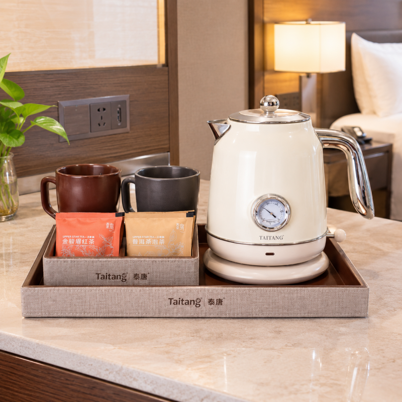 1.Taitang luxury electric kettle with tray set displayed on a hotel guest room tabletop including tea sachet organizer box and ceramic mugs.png