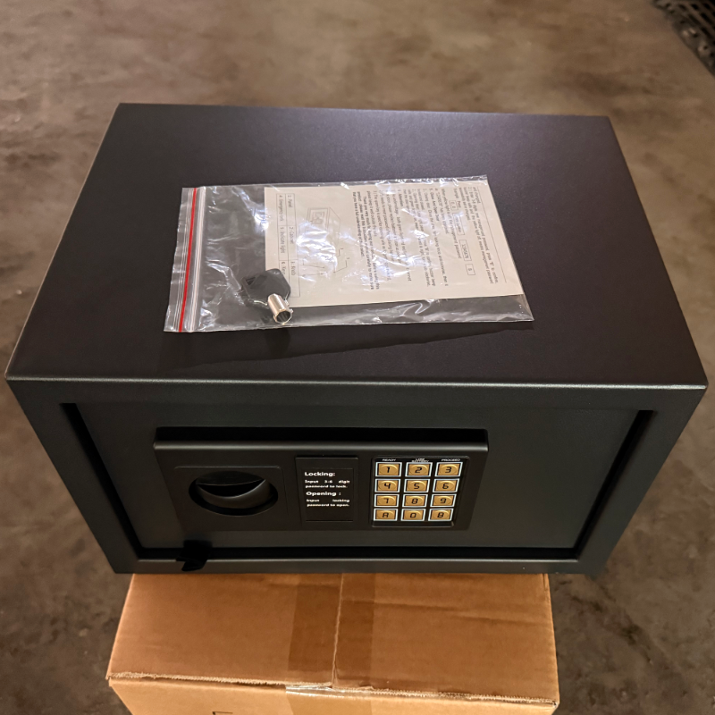 Black commercial hotel guestroom electronic safe box with digital keypad and manual override keys undergoing quality check.png