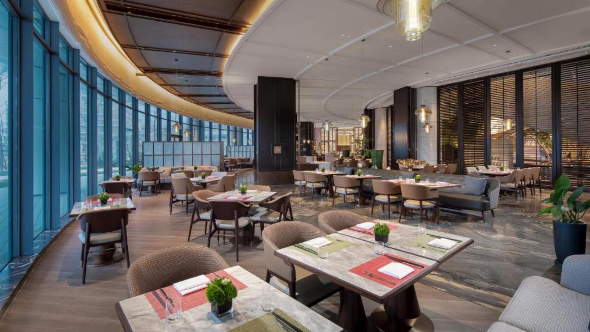 Commercial dining room chairs and restaurant tables custom manufactured by Taitang for the luxury dining area at Wyndham Grand Shanxi..jpg