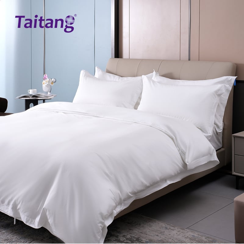 Taitang luxury hotel bed linen draping smoothly over a premium mattress to demonstrate a flawless hotel style bedding look.jpg