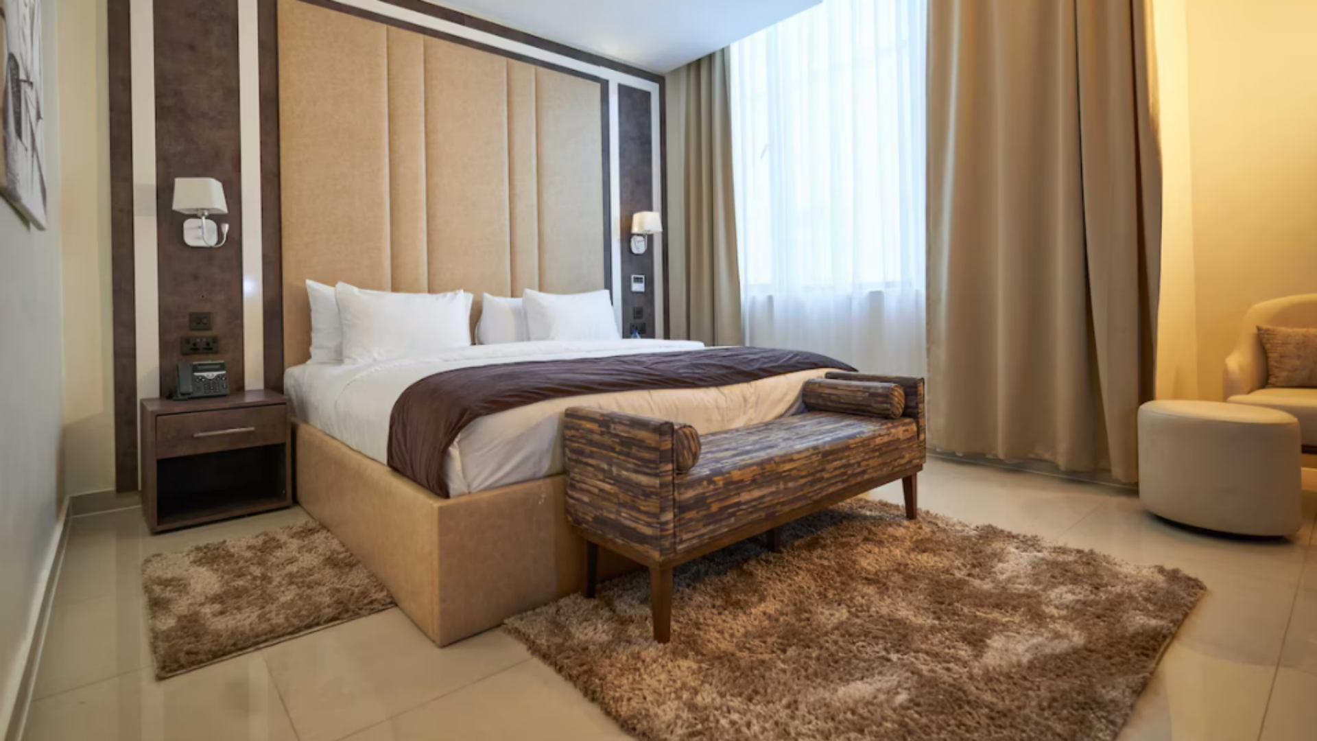 Inside a luxury 4-star executive room at Monty Suites, showcasing premium hotel bedding with crisp white linens supplied by Taitang.png