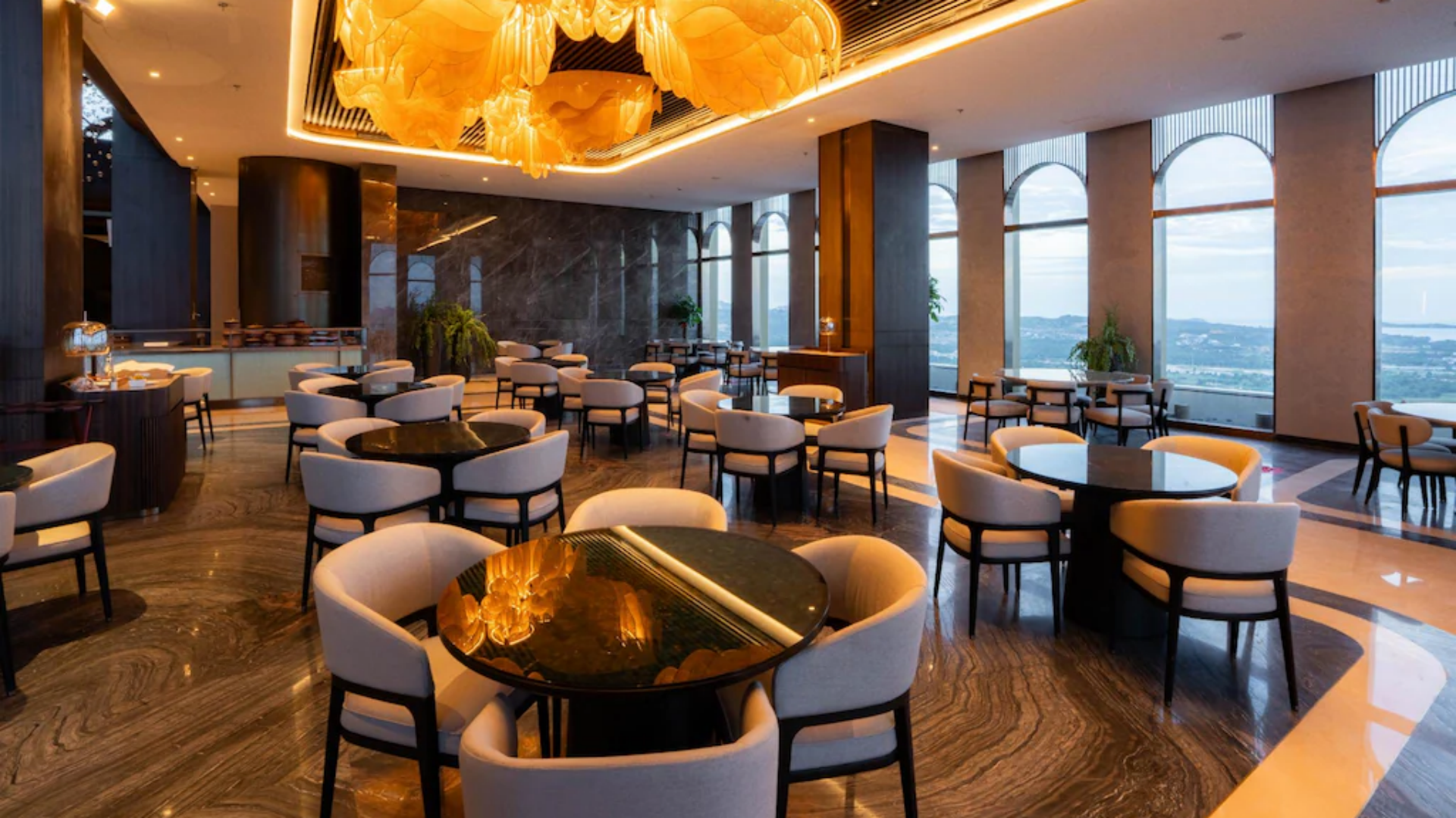 Elegant interior design of the high-rise sky dining room at Arjuna Solitaire Hotel, styled using Taitang’s one-stop hotel integrated resort procurement and commercial fine dining tableware wholesale collections.jpg