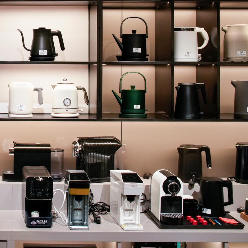 Taitang showroom display featuring commercial hotel room coffee machines and electric kettles for B2B hospitality procurement.JPG