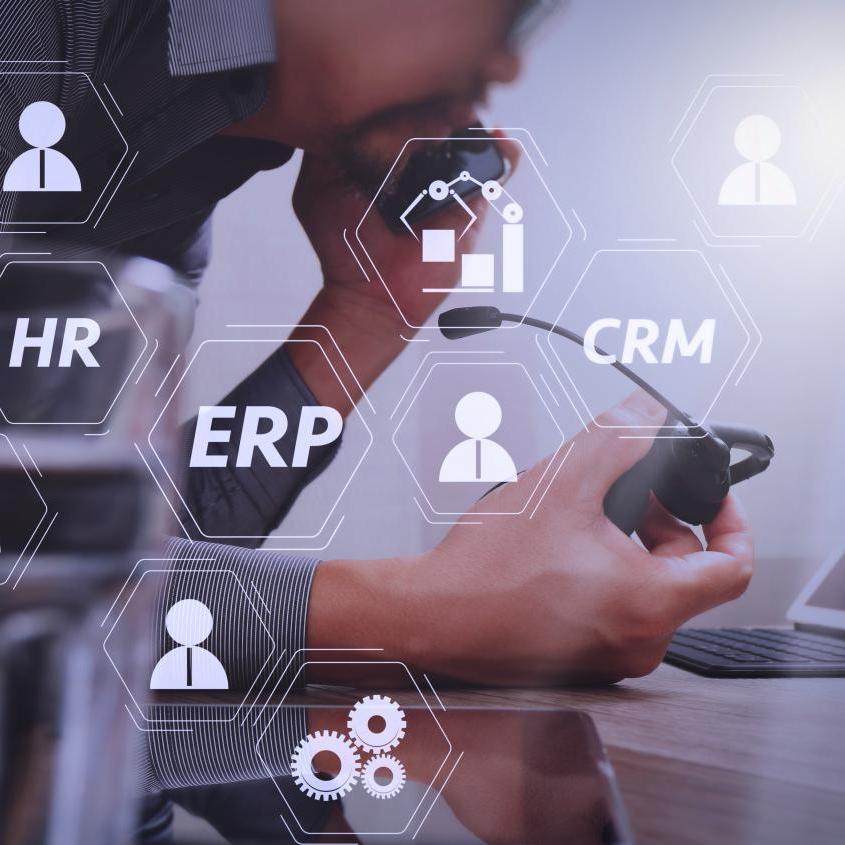 Digital overlay showing HR, ERP, and CRM business system icons, representing integrated hotel operational technology setup.jpg
